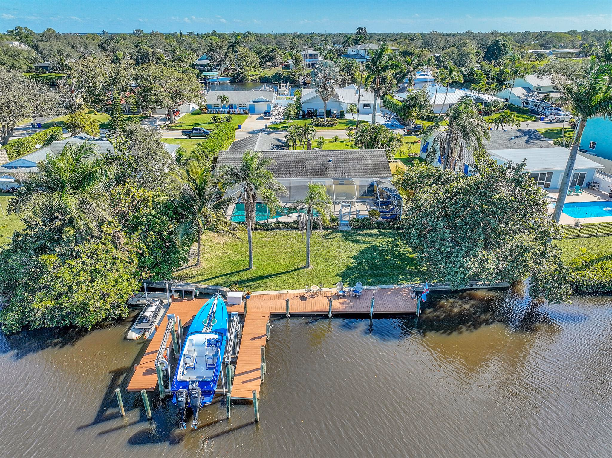 Aerial view of waterfront homes and a dock.